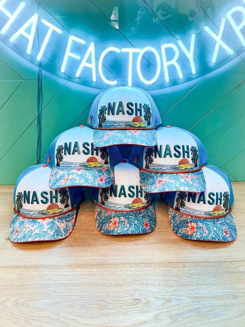 Six real NASH hats stacked under our neon sign