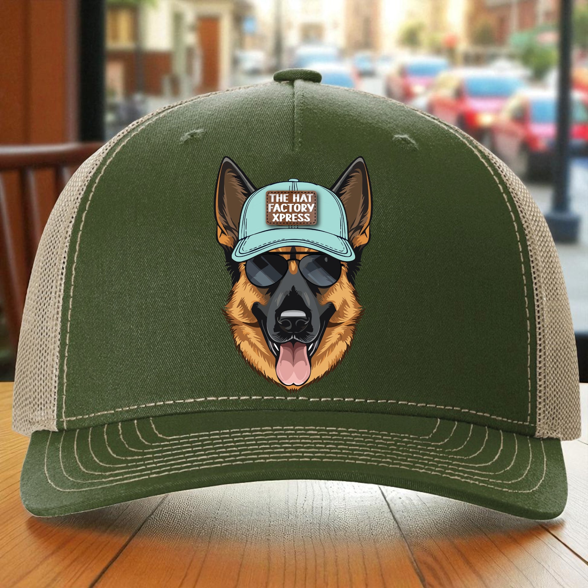 Green cap with a dog wearing a blue cap and sunglasses on a wooden surface.
