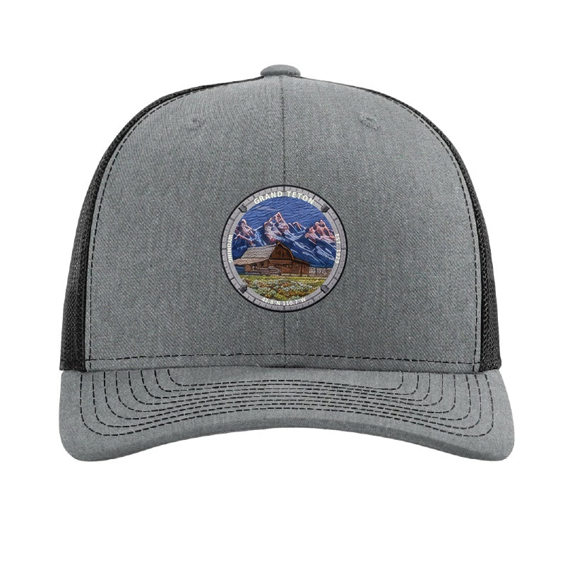 Grand Teton National Park patch hat in Heather Grey/Black — Moulton Barn and the Tetons badge on a Richardson 112 trucker cap