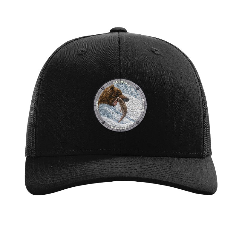 Katmai National Park patch hat in Black — brown bear catching salmon at Brooks Falls badge on a Richardson 112 trucker cap