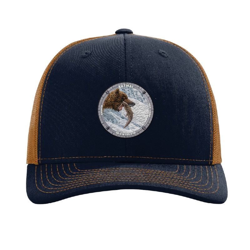 Katmai National Park patch hat in Navy/Caramel — brown bear catching salmon at Brooks Falls badge on a Richardson 112 trucker cap