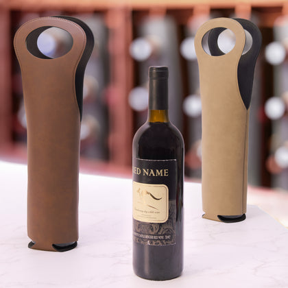 Leatherette wine bottle carriers in brown and tan beside a bottle of red wine
