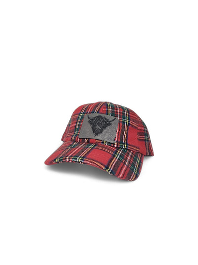 Red tartan trucker hat with an engraved Highland cow patch on grey leather