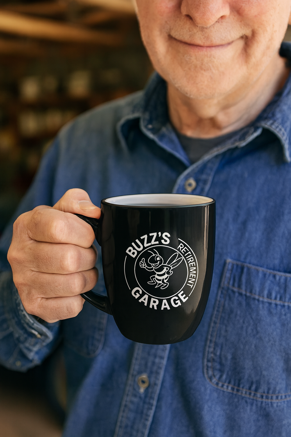Man holding a black mug with 'Buzz's Retirement Garage' logo, wearing a blue shirt.