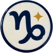 Capricorn hat button side patch: a Capricorn zodiac glyph on a white domed button. Zodiac collection.