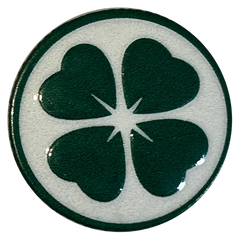 A real LFX button: a glossy raised green four-leaf clover, about three quarters of an inch across