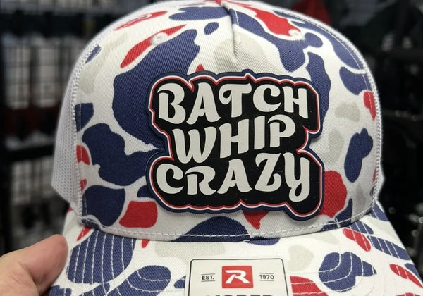 Contour-cut full-color patch reading Batch Whip Crazy on a red, white and blue camo Richardson 112PFP trucker hat.
