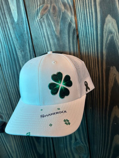 Three-quarter view of the Shanerock hat showing the clover's polished finish and the gold ribbon on the side