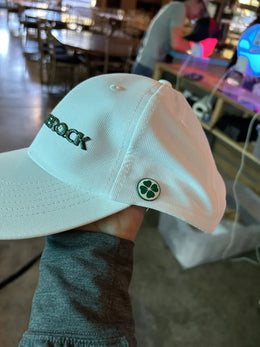 The same clover button installed on the side of a white hat