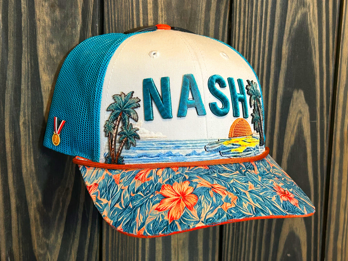 The finished NASH trucker hat at a three-quarter angle: raised teal NASH lettering between two palm trees, a copper sunset over blue water, an orange rope, an orange-and-teal hibiscus brim, and a gold medal on the teal mesh side panel.