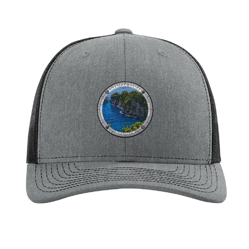 American Samoa National Park patch hat in Heather Grey/Black — jungle sea cliffs badge on a Richardson 112 trucker cap