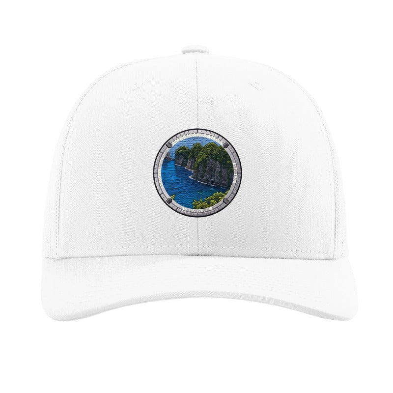 American Samoa National Park patch hat in White — jungle sea cliffs badge on a Richardson 112 trucker cap