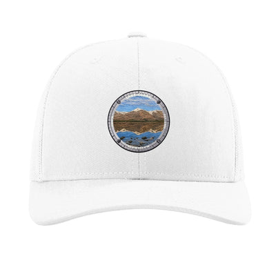 Lake Clark National Park patch hat in White — turquoise lake below snow-capped peaks badge on a Richardson 112 trucker cap