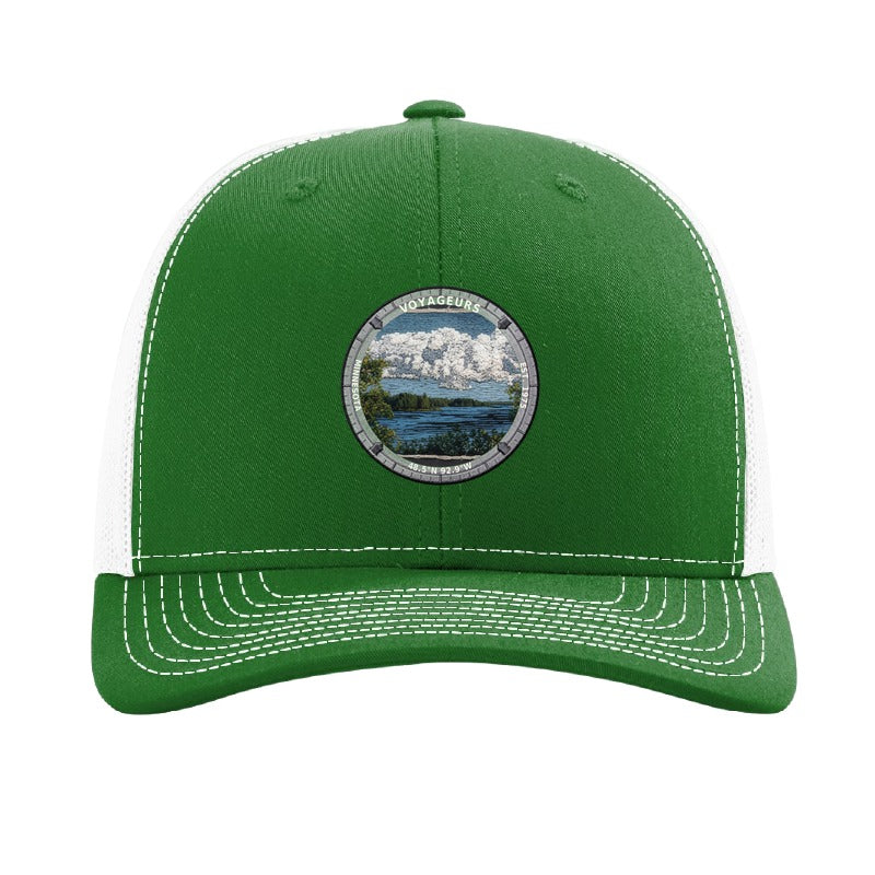Voyageurs National Park patch hat in Kelly Green/White — lake and pine shoreline badge on a Richardson 112 trucker cap