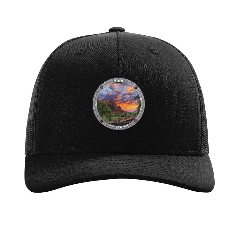 Zion National Park patch hat in Black — red sandstone cliffs at sunset badge on a Richardson 112 trucker cap