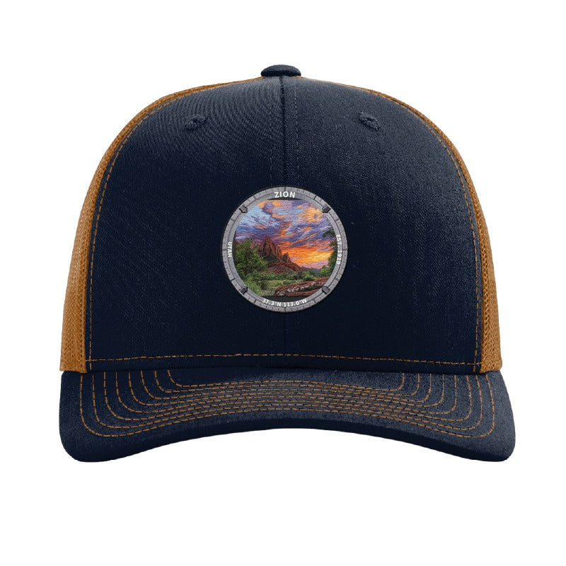 Zion National Park patch hat in Navy/Caramel — red sandstone cliffs at sunset badge on a Richardson 112 trucker cap