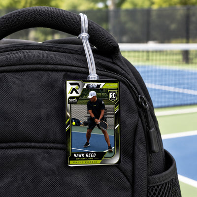 Rally bag tag on a backpack handle: two-sided acrylic tag with the player's Rally card and a clear loop