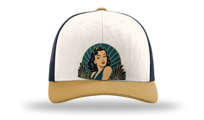 The Starlet art deco pin-up hat on a Richardson 112 trucker in Cream/Navy/Amber Gold