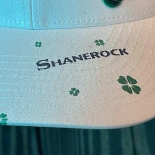 SHANEROCK printed directly onto the white bill of a cap, with small green clovers around it